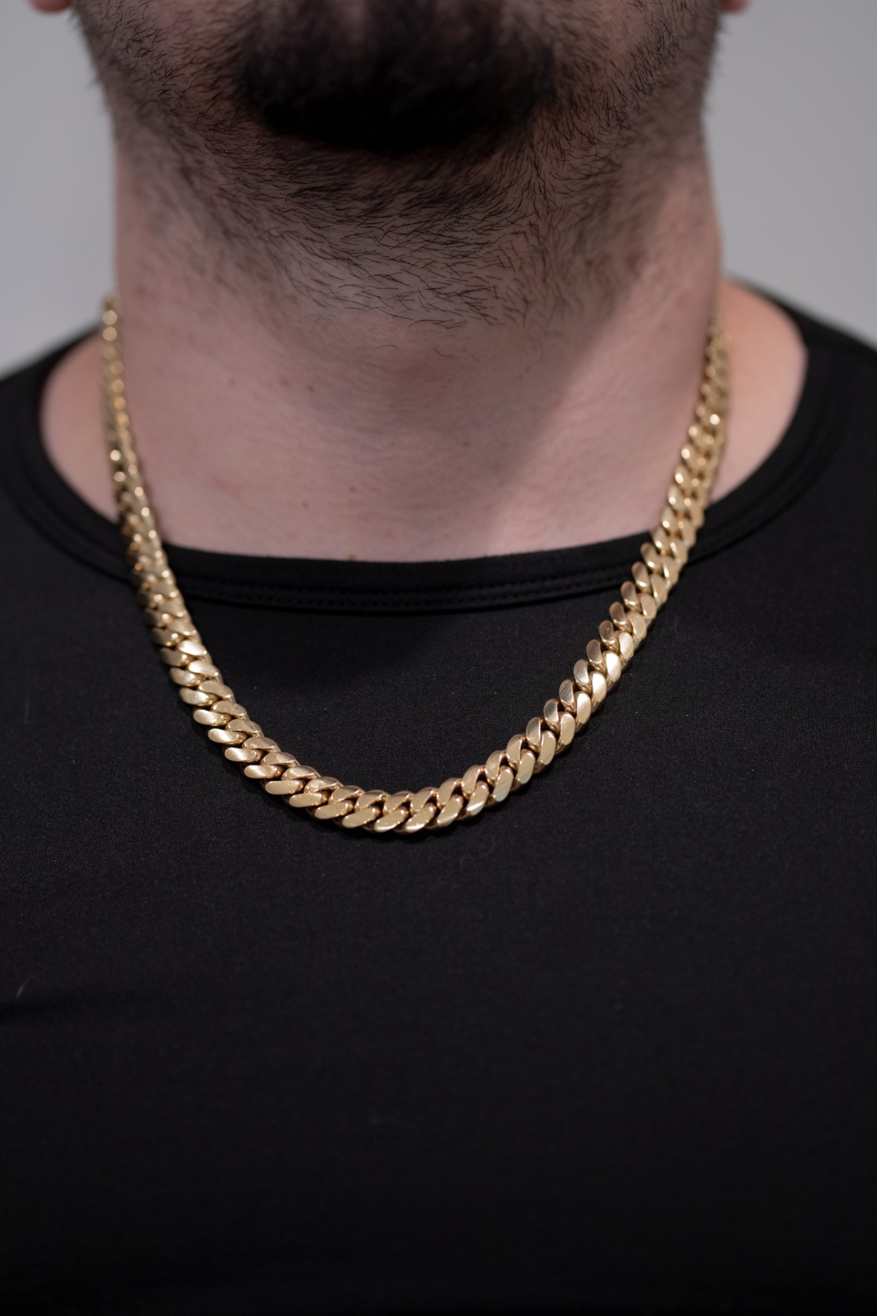 10mm 22 inch gold bonded Cuban link chain worn on a model